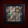 Repurposed black shadow box frame featuring a vintage Bakelite cat familiar, celestial sun-disc, and a dream key against a sepia skulls and roses backdrop.