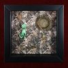 Detailed shot of a vintage Bakelite cat spirit guide curio and a repurposed vintage feline earring inside a traditional pagan shadow box.