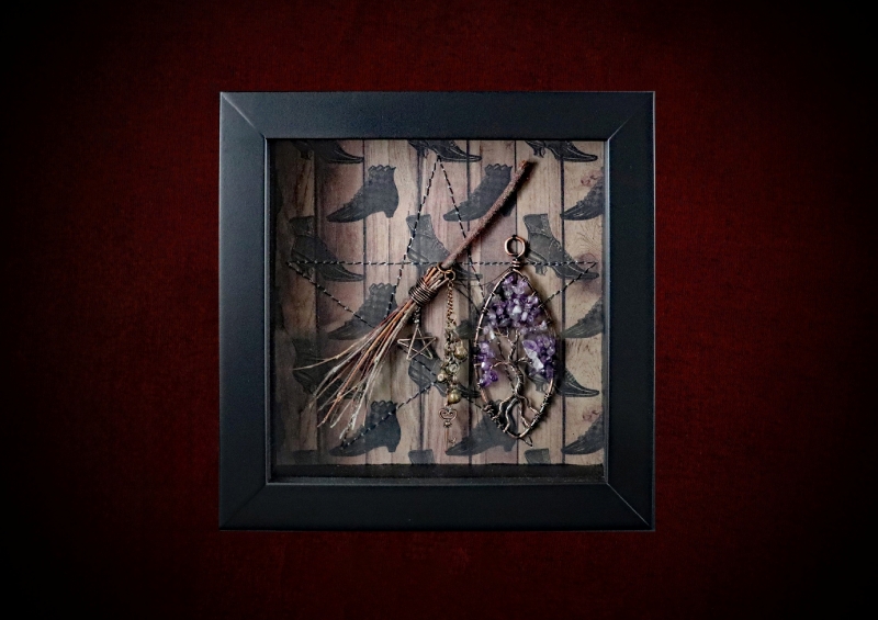 Repurposed black shadow box frame featuring a handmade willow witch besom and an amethyst tree of life on a witch's boots backdrop.