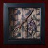 Detailed shot of a handcrafted full moon willow besom charm with attached witch bells and a pentagram inside a pagan curio frame.
