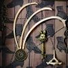 Detailed shot of three hare rib bones arching over an ornate hare-headed key with an authentic hare vertebra in an occult curio frame.