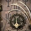 Detailed shot of three hare rib bones arching over a filigree disc with an authentic hare vertebra centrepiece inside a pagan curio frame.