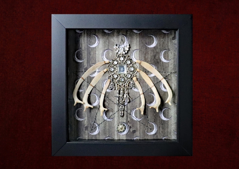 Detailed close-up of the central vintage diamante charm showing its hanging drops, including a skull and crossbones, skeleton, cross, and miniature stiletto shoes.