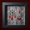 Close-up shot of the left side of the shadow box, highlighting the intricate metal dreamcatcher, its black onyx-coloured centre stone, skull charms, and bright red lorikeet feathers.