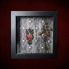 Repurposed black shadow box frame featuring an asymmetrical layout with a vintage filigree owl charm, three real owl feathers, an ornate metal key, and three animal bones on a skull and ivy backdrop.
