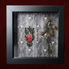 Close-up shot of the shadow box, highlighting three real owl feathers arranged beneath an authentic vintage metal earring, with an ornate metal key sitting just below them.